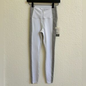 Never worn Vuori leggings with fake zipper front